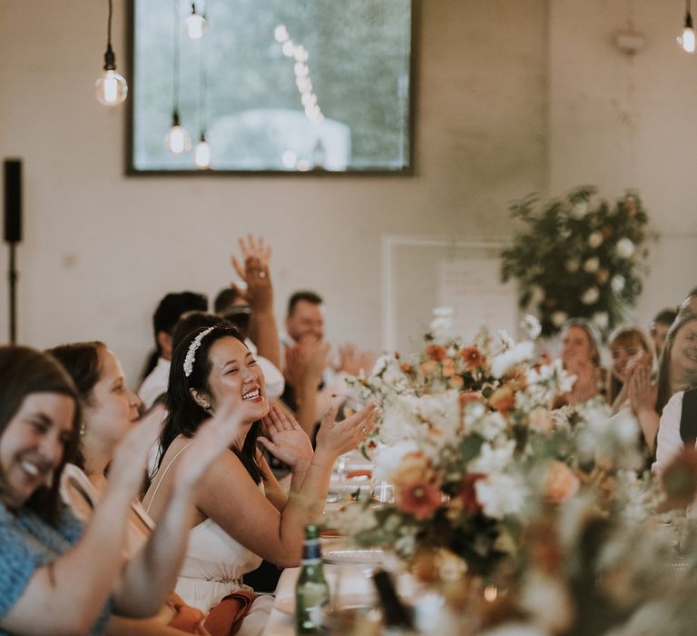 Bride in a headband smiling at Osea Island wedding reception 