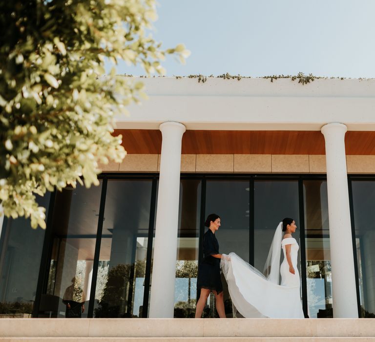 Bride & groom stand on staircase together on their wedding day | Hannah MacGregor Photo & Film