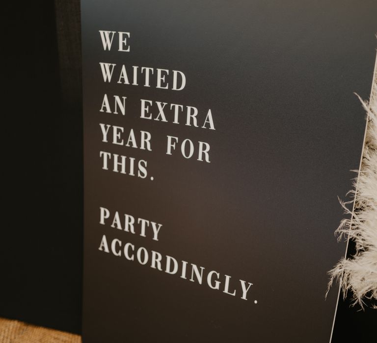 Personalised black board asking guests to 'party accordingly' due to extra wait for wedding day | Mark Bamforth Photography