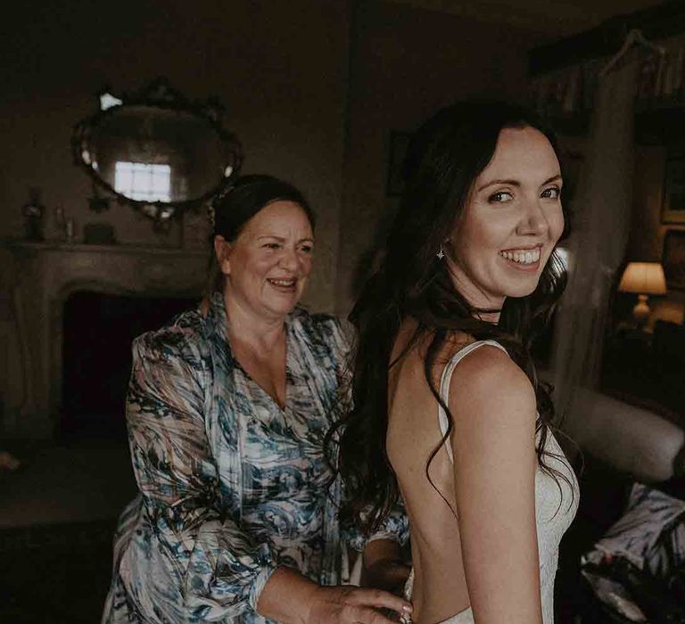 Beautiful bride smiles during preparations 