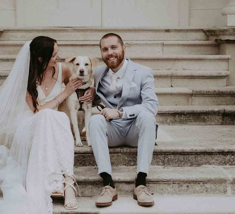 Bride and groom with their pet dog at wedding