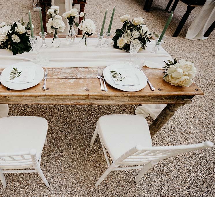 Rustic tablescape complete with white table runner and white florals  | Royal Studio