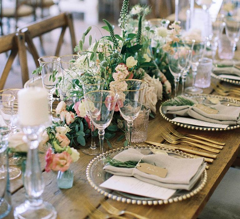 rustic barn wedding centrepiece with foliage, white and pink flowers 