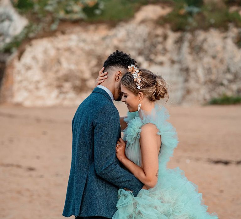 Coastal wedding inspiration at Botany Bay, Kent with bride in a mint green wedding dress and groom a blue wool suit 