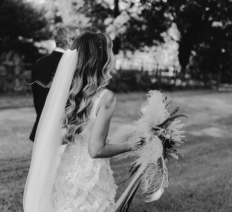 Bride & groom walk with one another on their wedding day