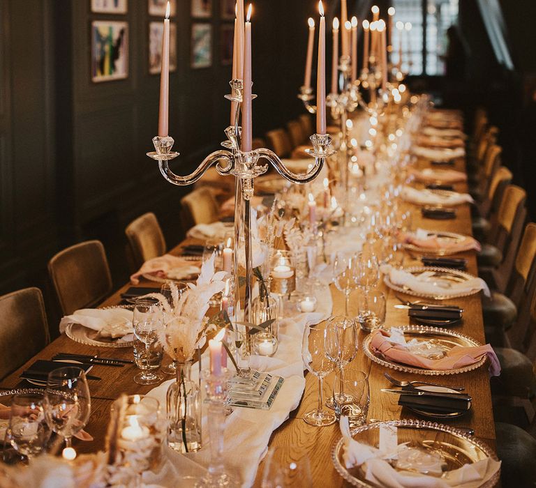 romantic wedding reception with glass charger plates and candelabras and pink taper candles 