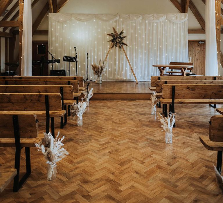 Beautiful barn ceremony with pampas grass decor