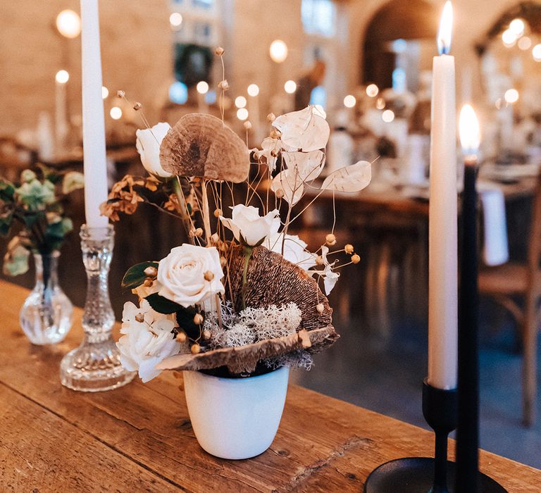 Wedding table decor with black candlestick holders, white vases and dried flowers 