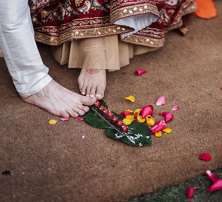 Bride and groom take part in customs for traditional Indian wedding ceremony