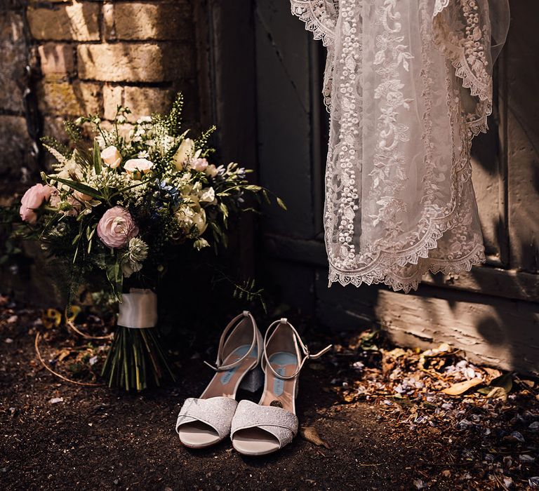 Bride's Charlotte Mills wedding shoes and lace embroidered veil and bridal bouquet 