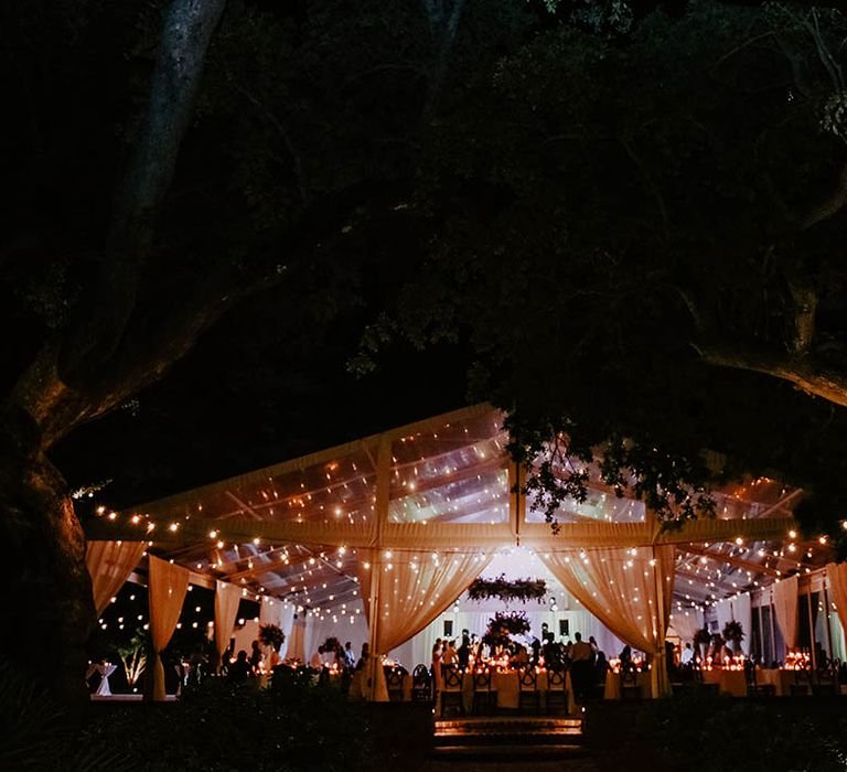 Wedding reception venue with drapes and fairy lights 