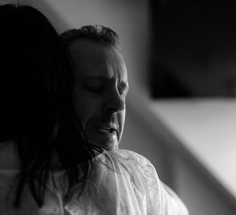 Black and white image of father hugging his daughter on wedding day 