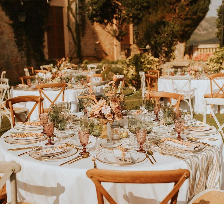 Mallorca destination wedding complete with round tables and pops of gold throughout for outdoor reception 