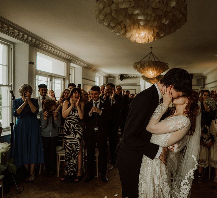 Bride & groom kiss within Belair House during gothic wedding ceremony with romantic feel 