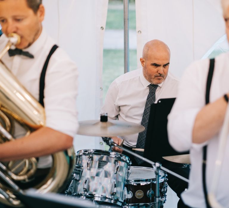 Wedding band play in marquee during reception