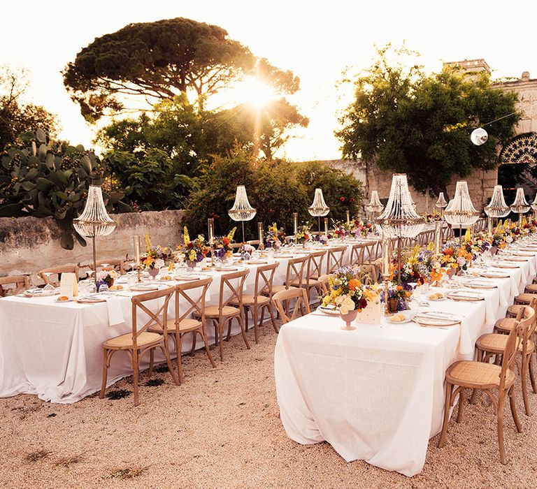 Destination wedding in Puglia, Italy with chandelier installations for the outdoor wedding reception 