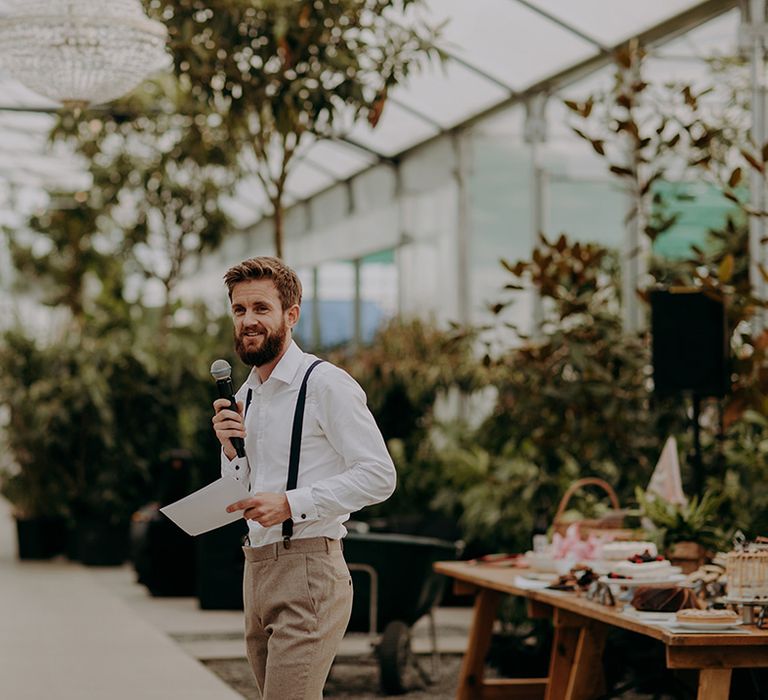 Groomsman doing a speech in front of greenery at the Architectural Plants Venue