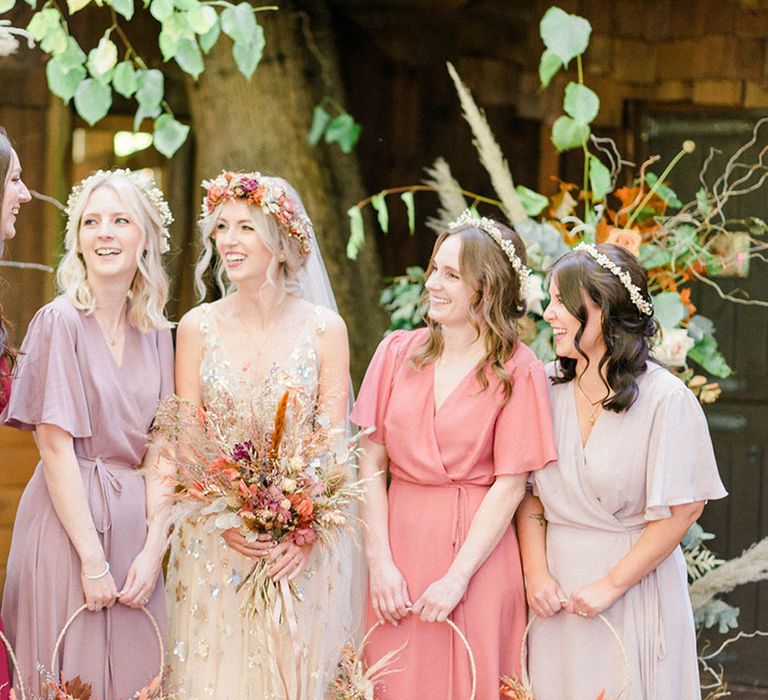 Bride in star sequin wedding dress stands beside her bridesmaids in Rewritten Bridesmaid dresses 