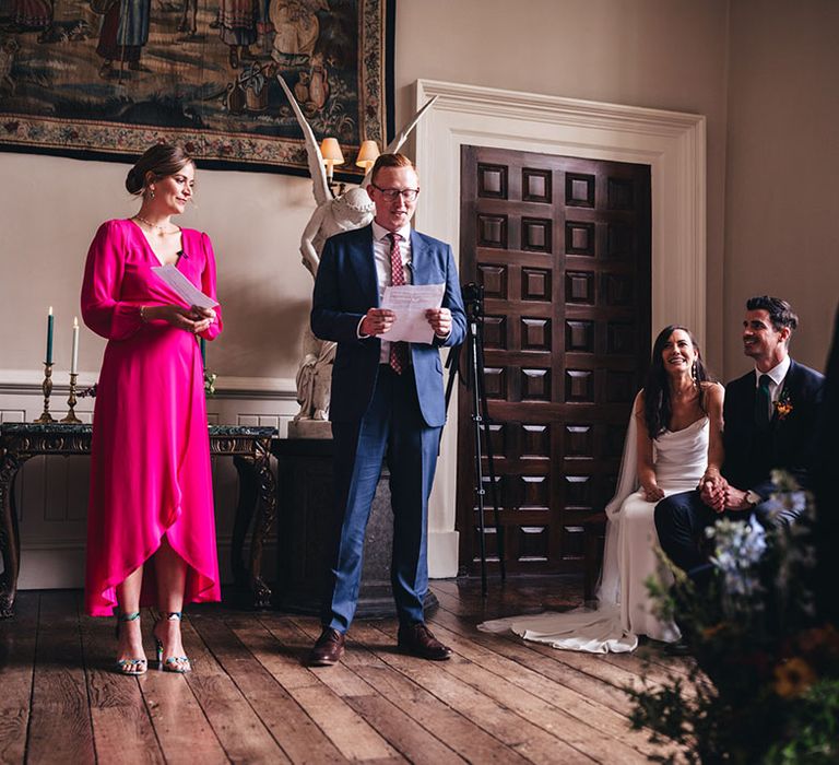 Wedding guests stand and give personal wedding readings at the wedding ceremony 