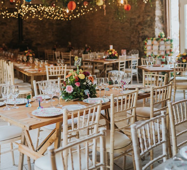 barn wedding reception with string lights and colourful flowers 