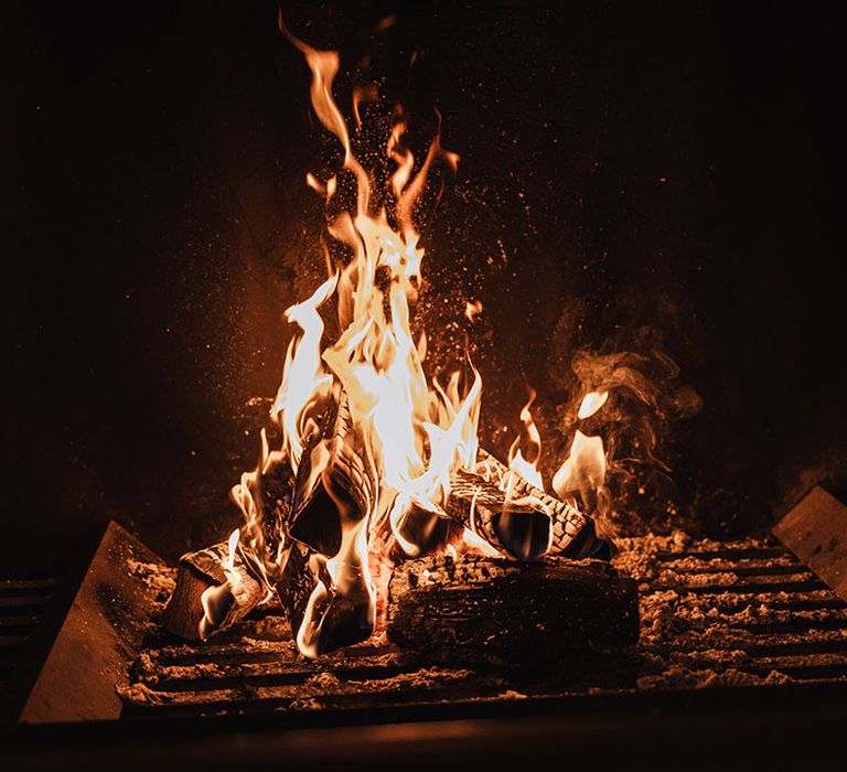 A roaring fire to keep everyone warm on the snowy November wedding