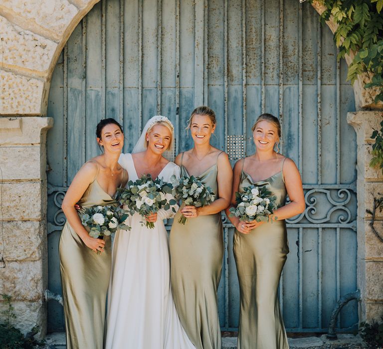 bridal party photograph with sage green satin bridesmaid dresses 