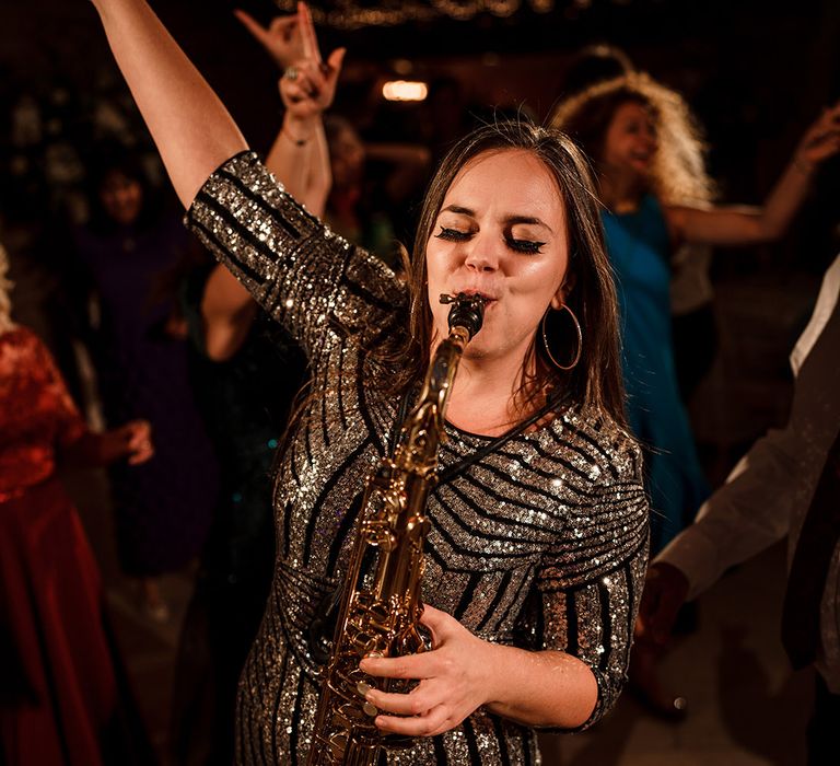 saxophonist wedding entertainer playing during the evening reception 