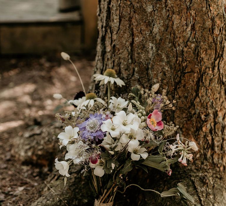 British grown purple and white wildflowers make up the bride's wedding bouquet 