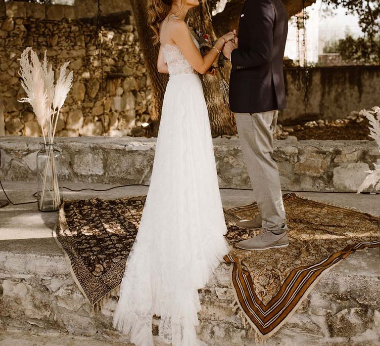 confetti moment at greece destination wedding with bride in a lace wedding dress and groom in a navy blazer