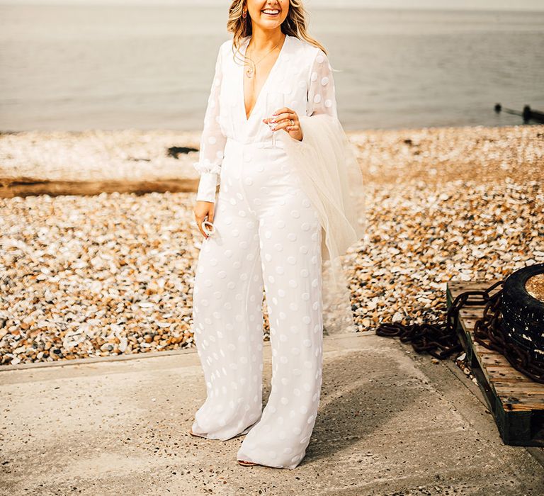 bride in a long sleeve and wide leg Nikeen Asar jumpsuit at East Quay Whitstable wedding 