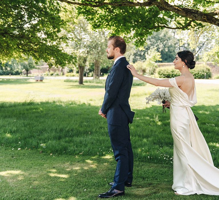 Emotional first look moment of the bride and groom 