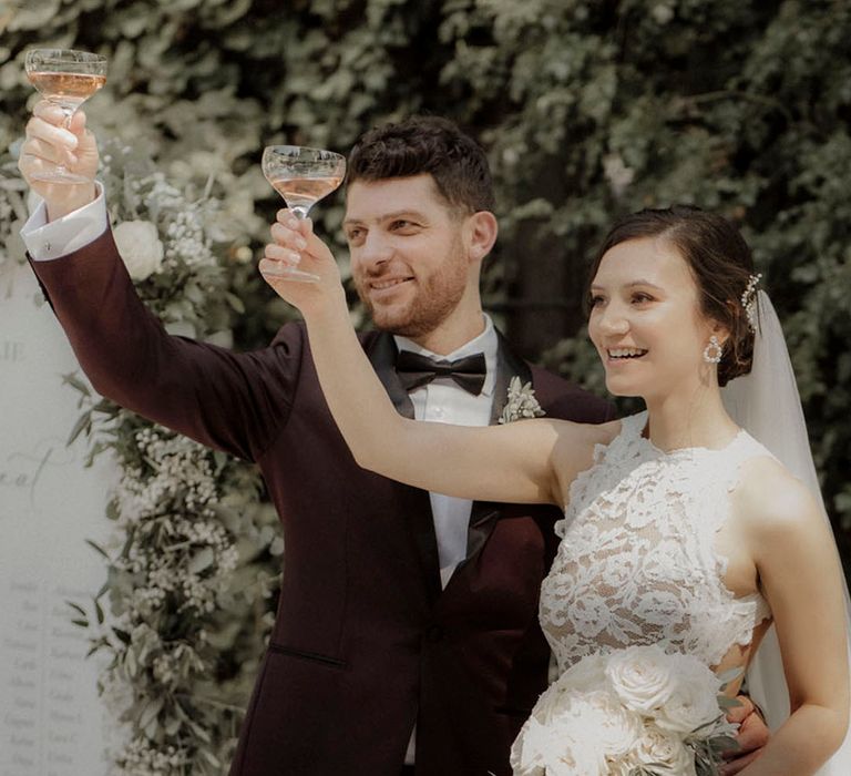 Bride and groom toast together at their outdoor wedding 