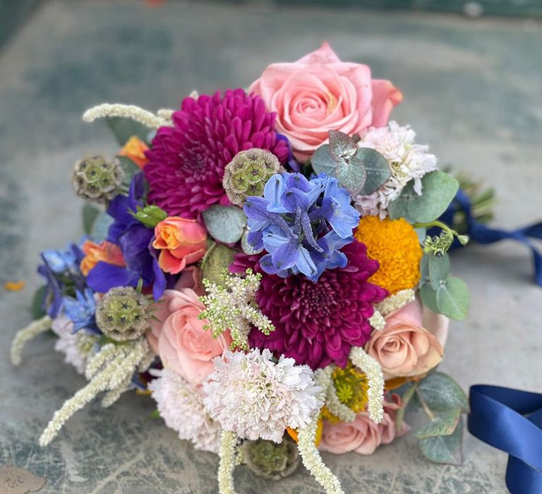 Bright and bold wedding bouquet with dahlias and roses 