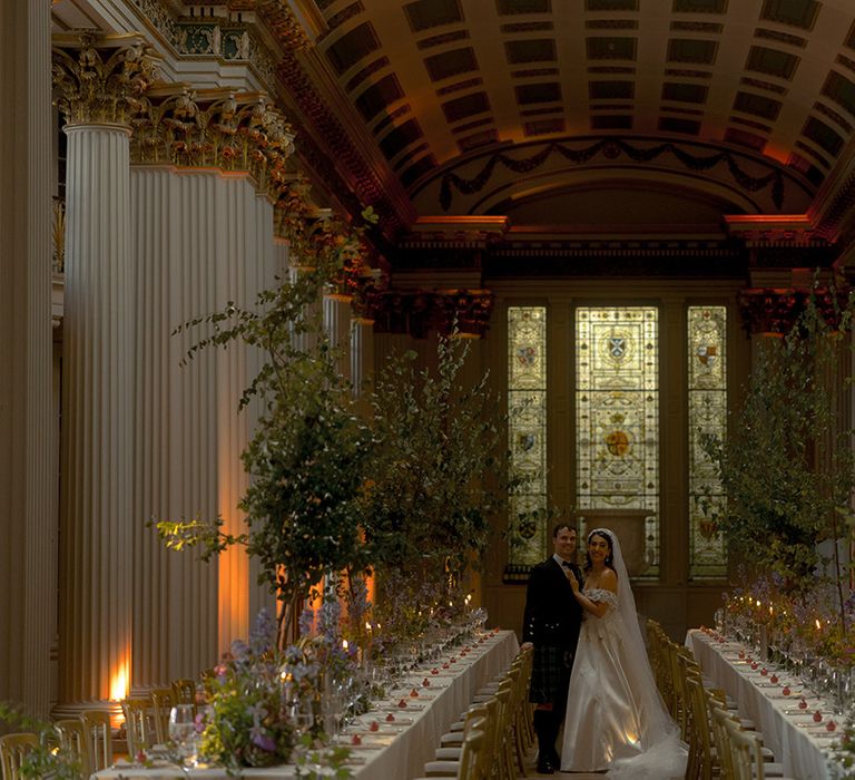 The bride and groom stand in the middle of their wedding breakfast at Signet Library 