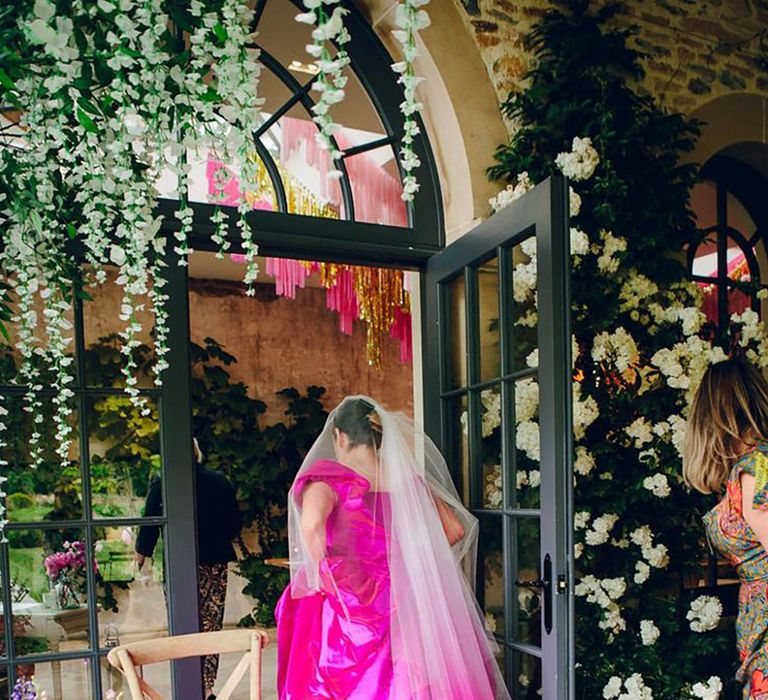 Bride in Vivienne Westwood wedding dress in magenta shade 