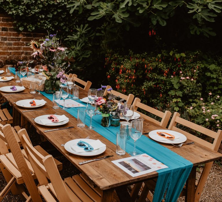 rainbow wedding table decor and details at outdoor reception 