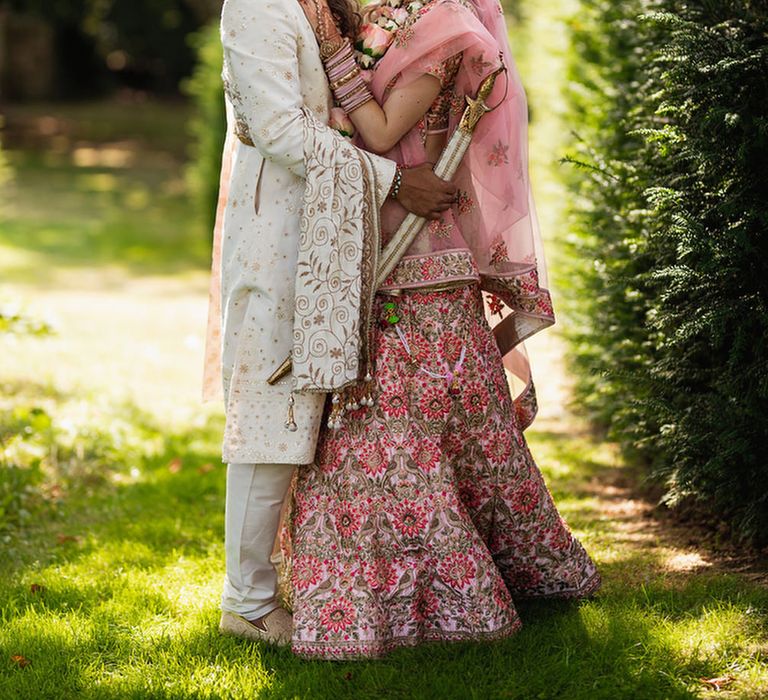 Bride and groom in traditional Indian wedding outfits 