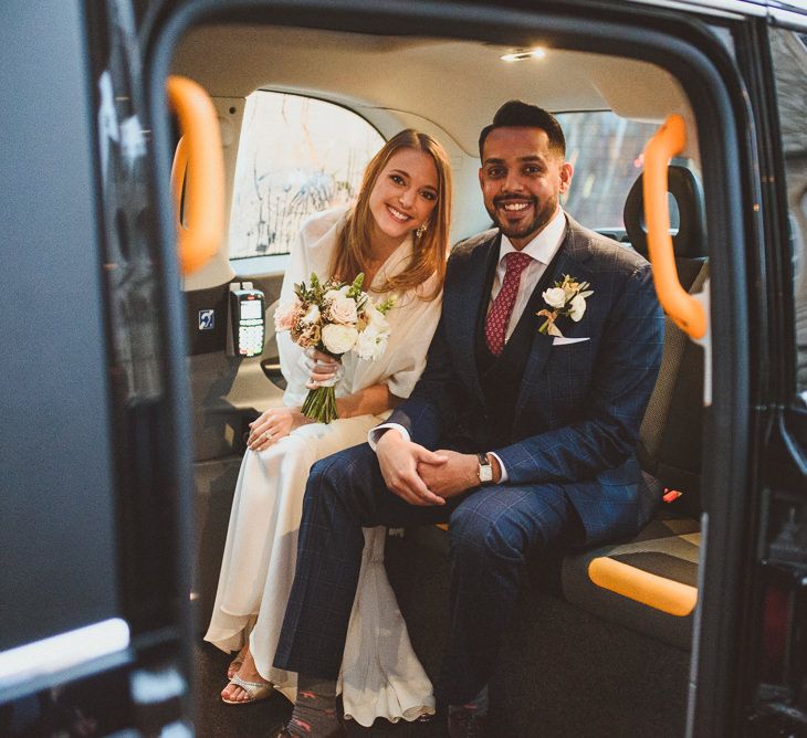 Couple on their Wedding Day in black cab on their way to The Orange Chelsea 