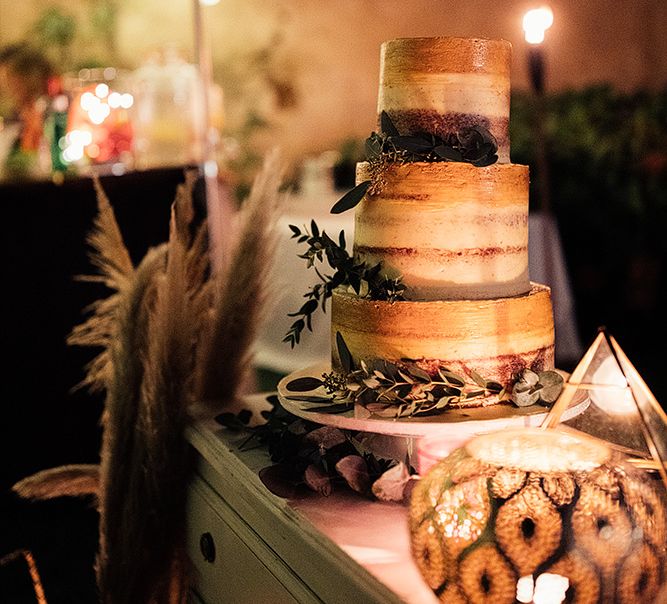 Rustic wedding cake at celebration with Moroccan themed wedding decor