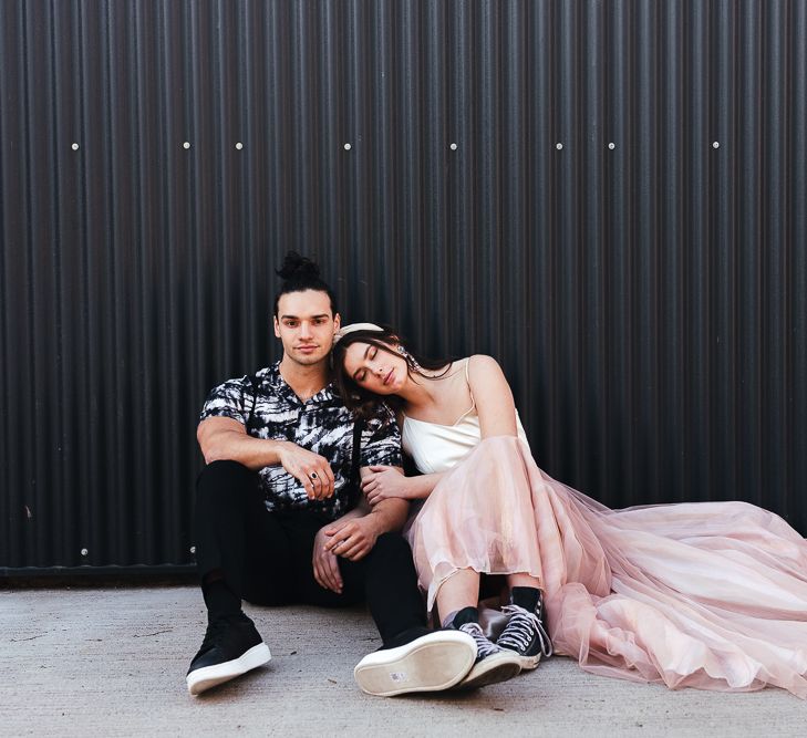 Bride in a pink tulle skirt and black trainers 