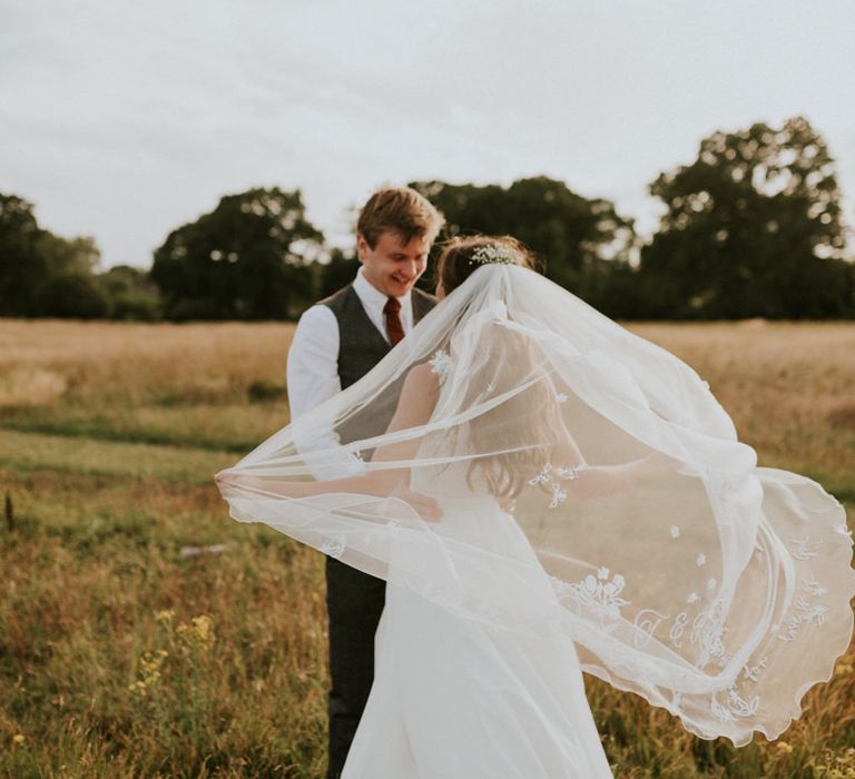 Chapel-length wedding veil billowing in the wind 