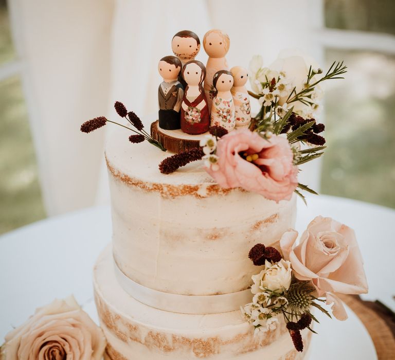 Semi naked wedding cake with wooden people cake topper 