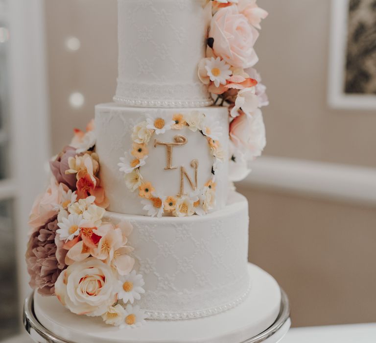 White iced wedding cake with real flower decor