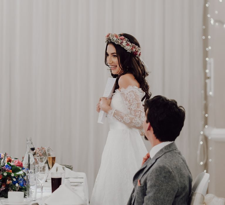 Bride reads her wedding vows at wedding breakfast in Asos bridal dress