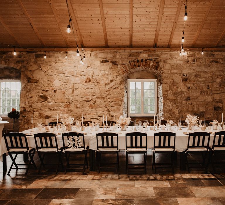 Rustic boho wedding table setting with pampas grass centrepieces