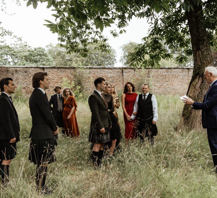 Wedding party gather during intimate Scottish elopement ceremony