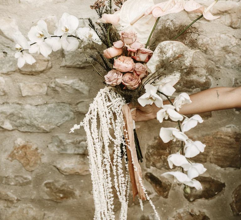 boho wedding flowers bouquet with pink roses, orchids, anthuriums and dried grasses 