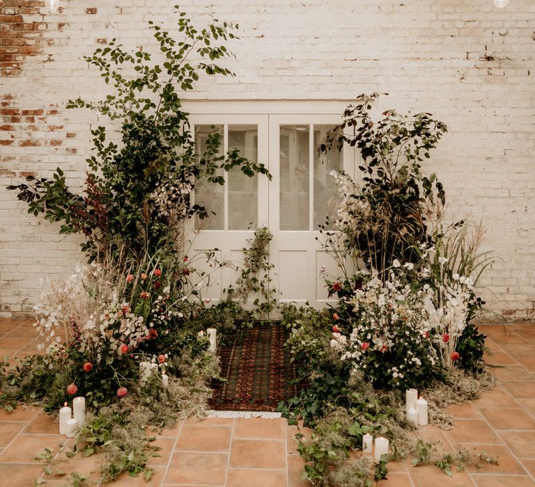 Elopement at Our Beautiful Glasshouse in Sussex with wildflower altar and wool rug detail 