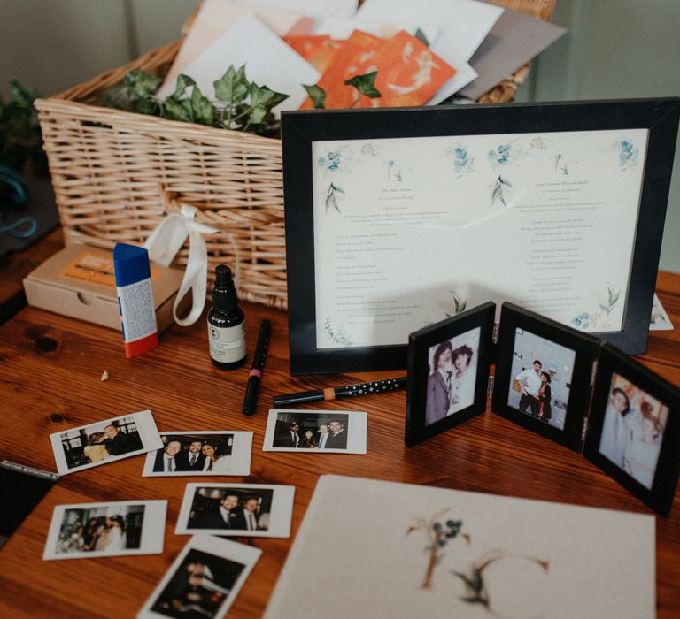 Hamper of wedding presents and cards, polaroid photos of the wedding day and a guest book on a table