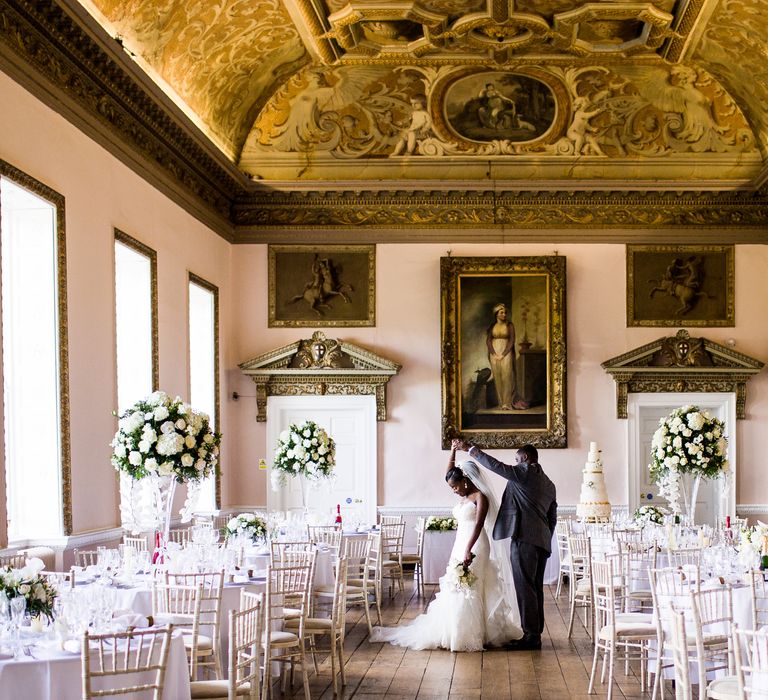 Elegant & stately room set for classic wedding reception with white tablecloths